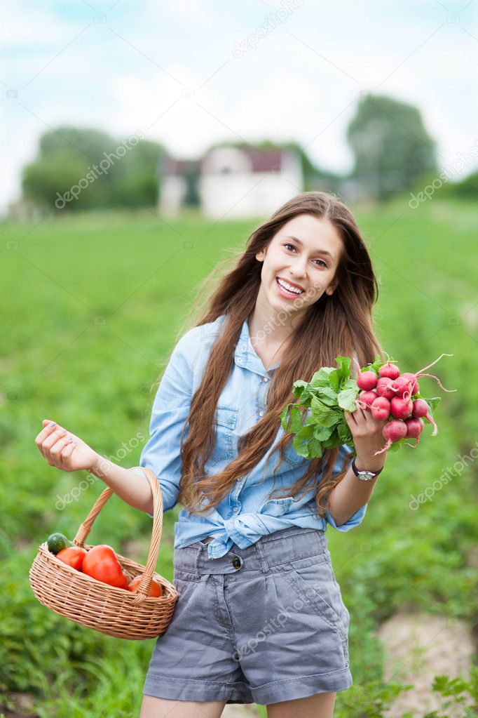 Woman with basket of harvested vegetables