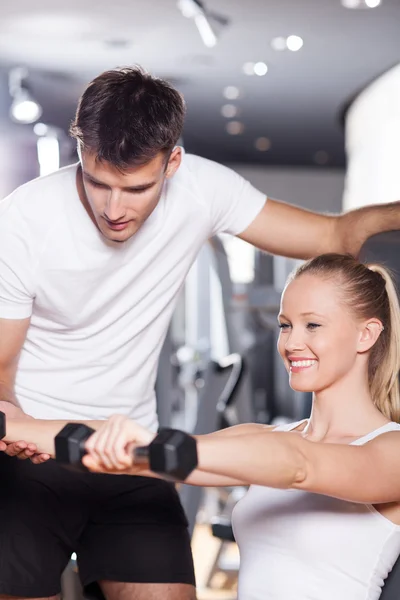 Trainer helps Woman Lifting Dumbbells — Stock Photo, Image