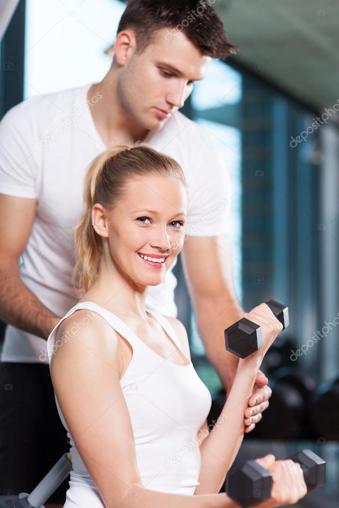 Woman exercising with personal trainer