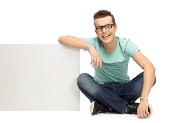 Young man holding blank placard — Stock Photo, Image