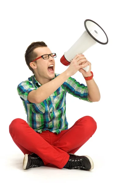 Young man shouting through megaphone — Stock Photo, Image