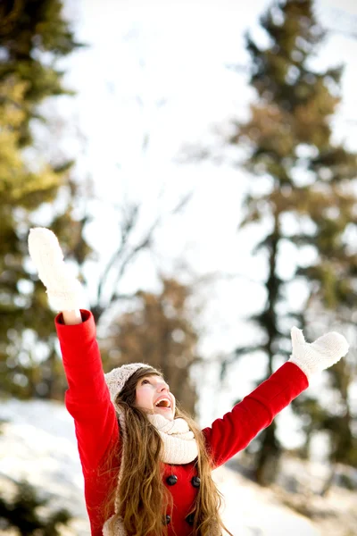 Woman outdoors with arms raised — Stock Photo, Image