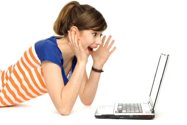 Surprised young woman using laptop — Stockfoto