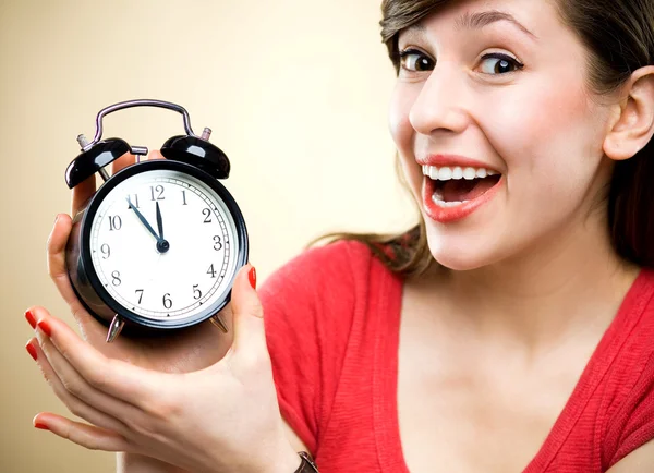 Young woman holding alarm clock — Stock Photo, Image