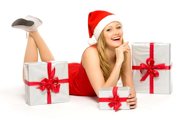 Woman in Santa hat holding gifts Stock Photo