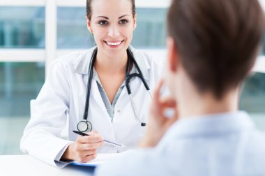 Female doctor talking to patient clipart