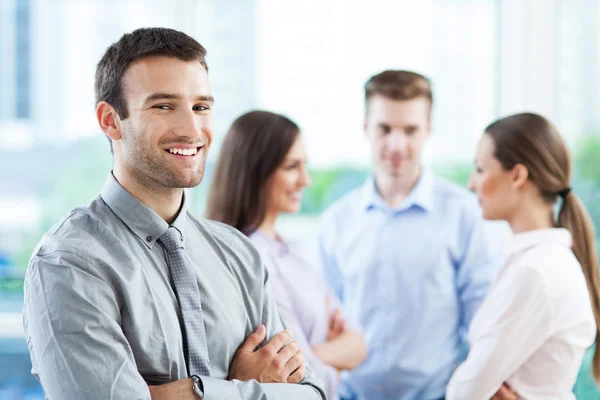 Businessman with coworkers in background Royalty Free Stock Images
