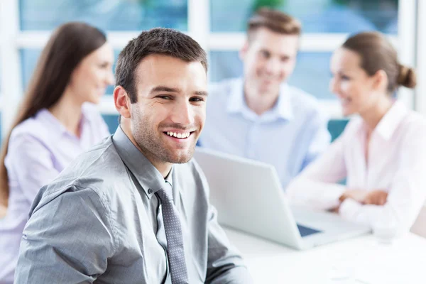 Businessman with coworkers in background Royalty Free Stock Images