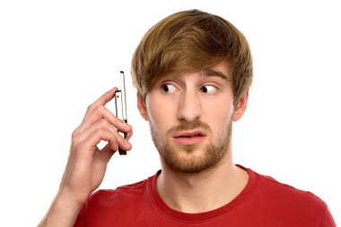 Confused man with mobile phone clipart