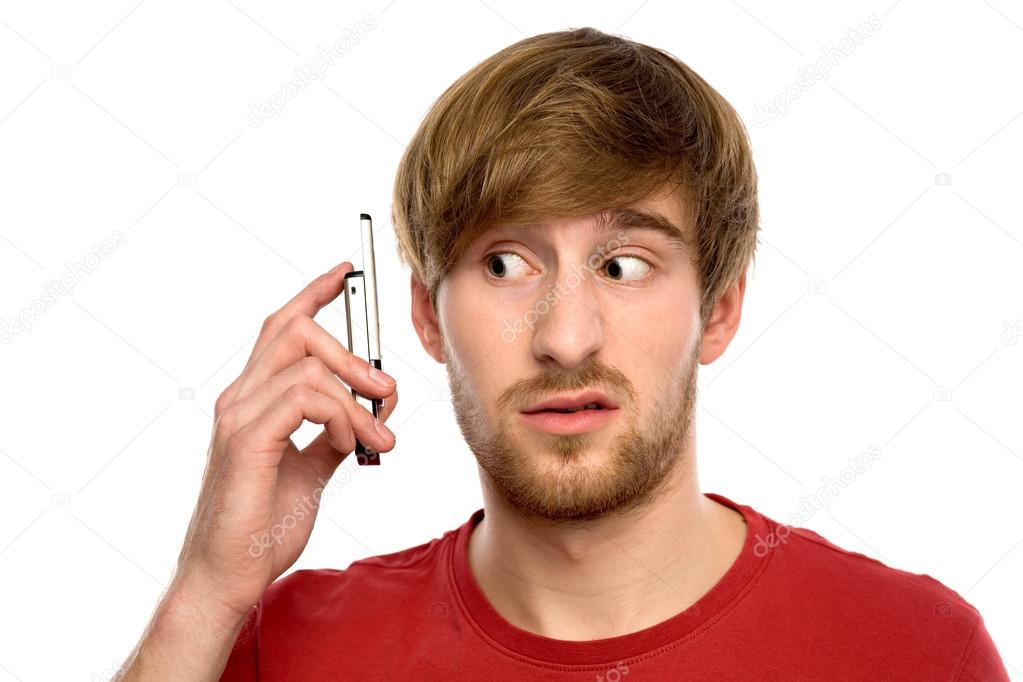 Confused man with mobile phone