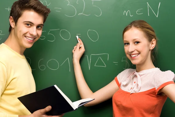 Students by chalkboard — Stock Photo, Image