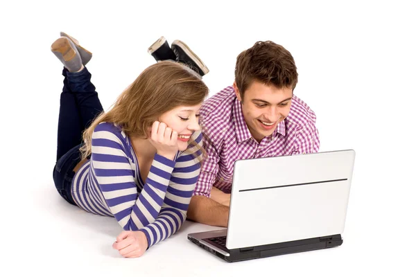 Teenage couple using laptop Stock Image