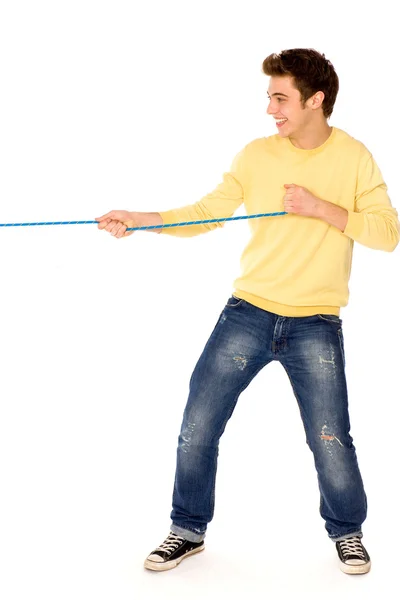 Young man pulling a rope — Stock Photo, Image