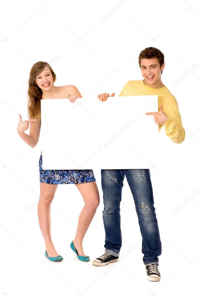 Young couple holding blank poster