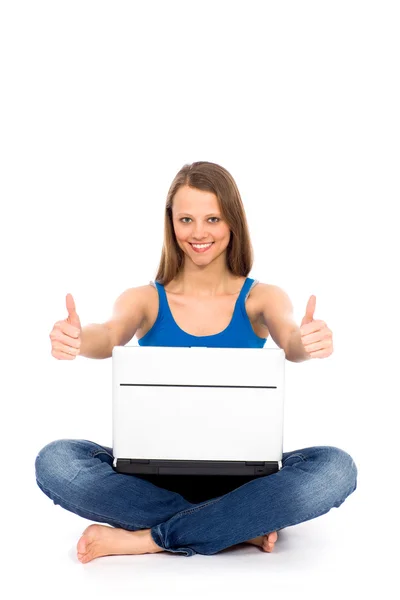 Girl with thumbs up using laptop — Stock Photo, Image