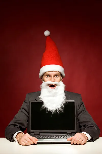 Santa met laptop — Stockfoto