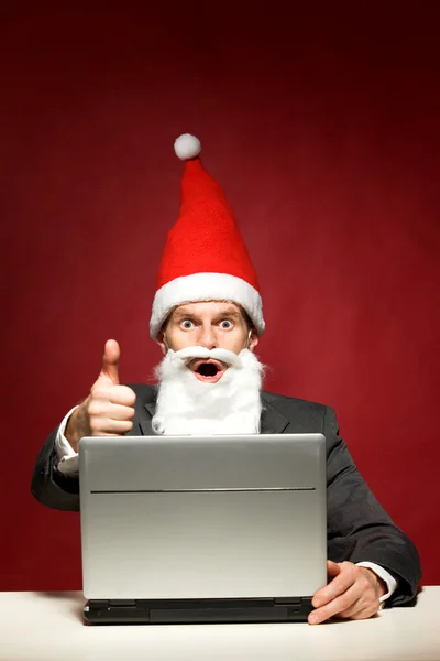 Moș Crăciun cu laptop Imagine de stoc
