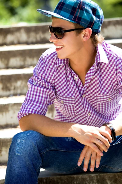 Casual guy sitting on stairs — Stock Photo, Image