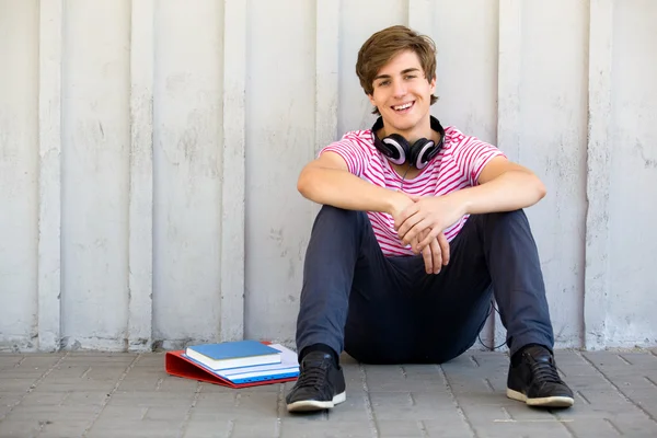 Young man sitting with books — Stock Photo, Image