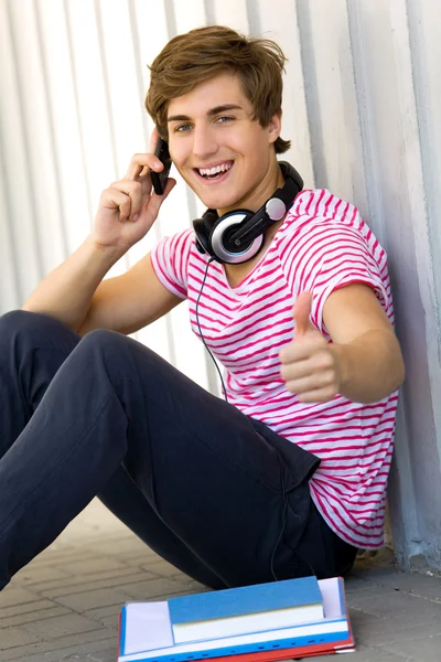 Young man sitting with books — Stock Photo, Image