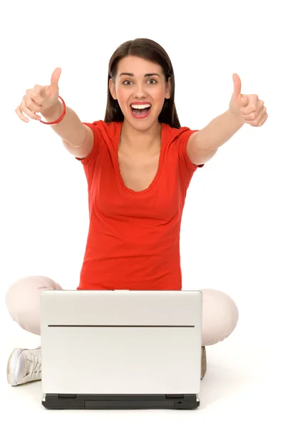 Girl with thumbs up using laptop — Stock Photo, Image