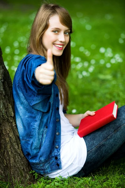Female student with thumbs up Stock Photo
