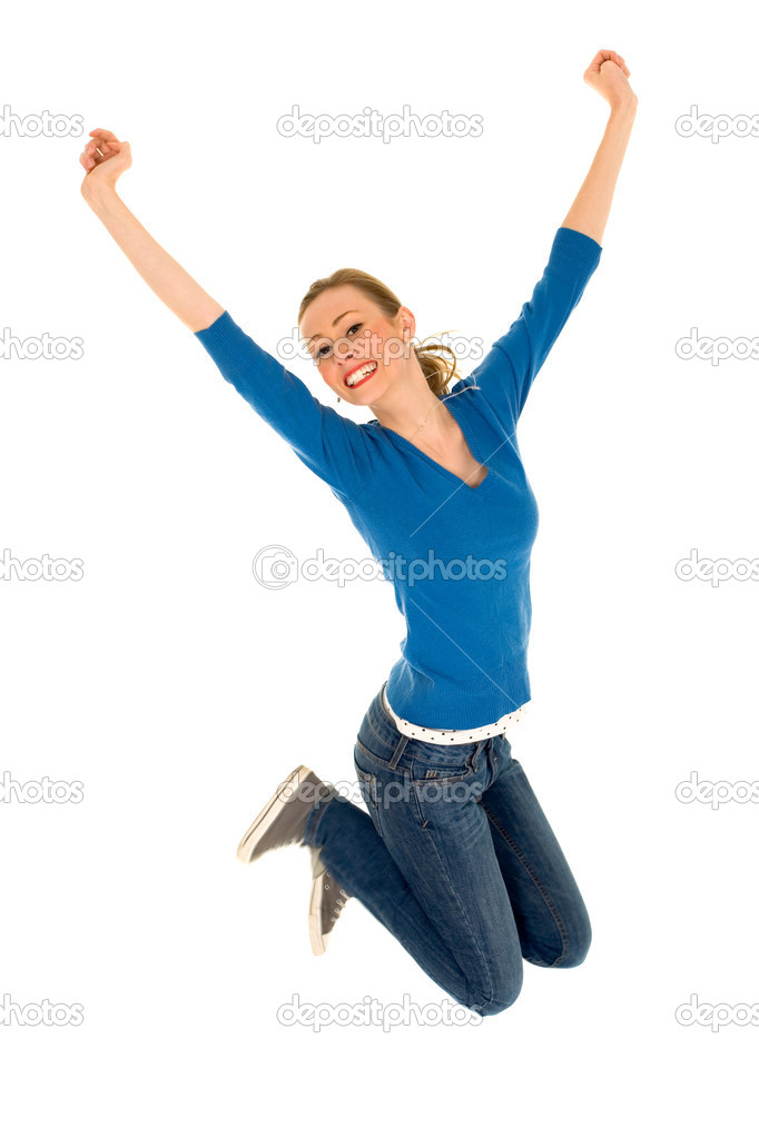 Teenager jumping with arms raised