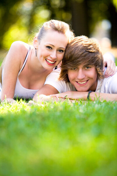 Couple lying down on grass