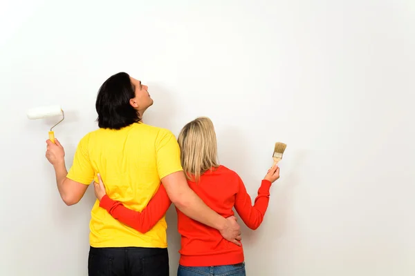 Casal com pincéis de pintura, vista traseira — Fotografia de Stock