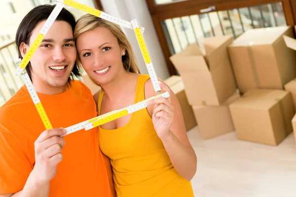 Holding folding ruler in the shape of a house — Stock Photo, Image