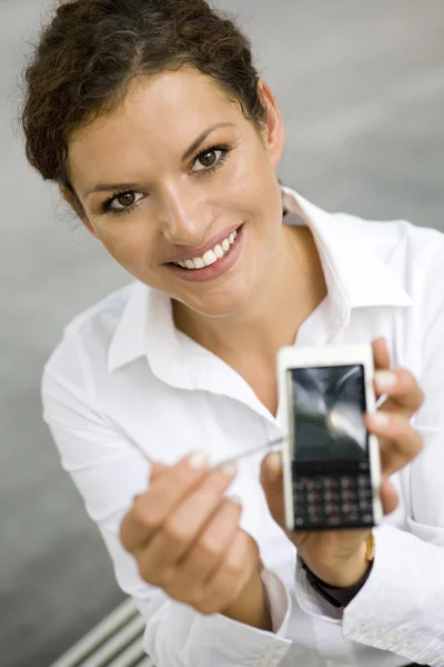 Businesswoman using palmtop outdoors — Stock Photo, Image
