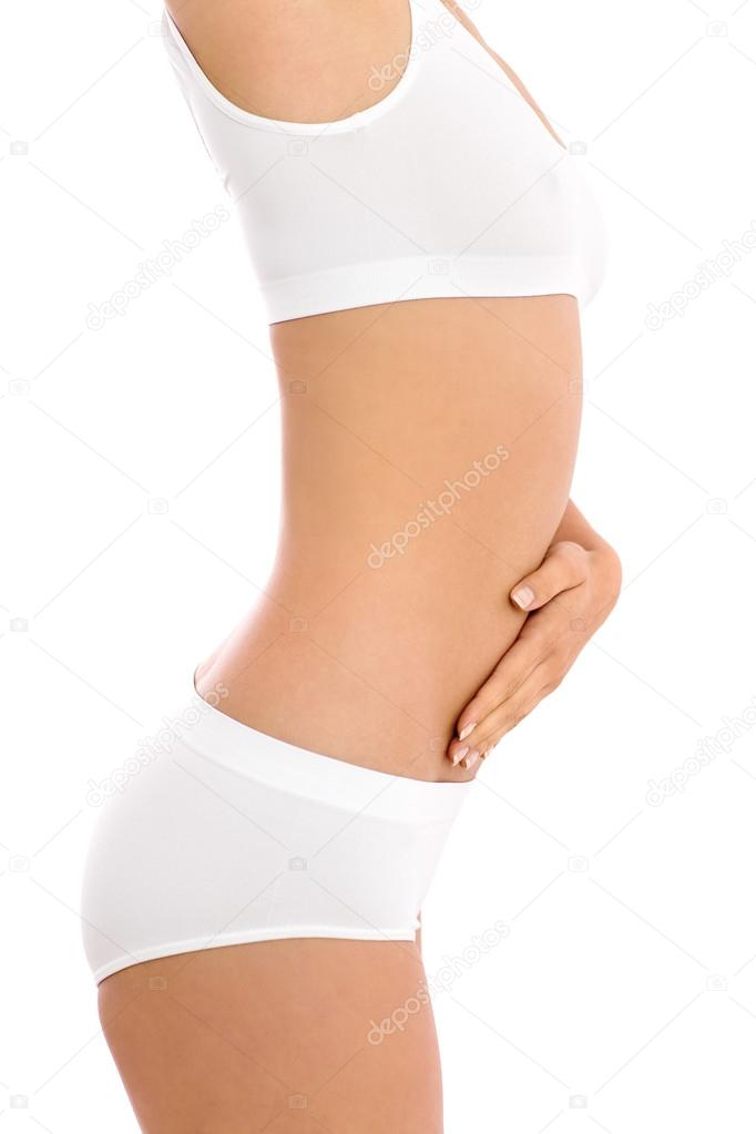 Woman in underclothes, touching abdomen