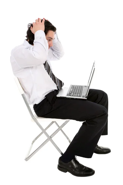 Businessman with laptop, holding head in hands — Stock Photo, Image