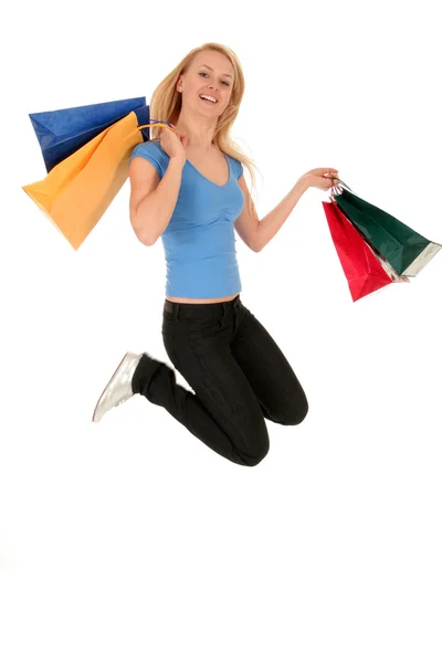 Femme sautant avec des sacs à provisions — Photo