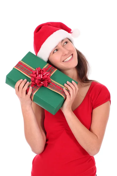 Молода жінка в капелюсі Санта, тримає подарунок Стокове Зображення