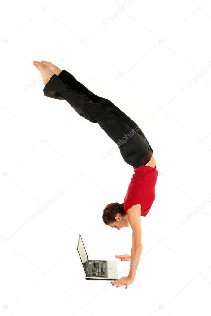 Woman doing handstand and using laptop