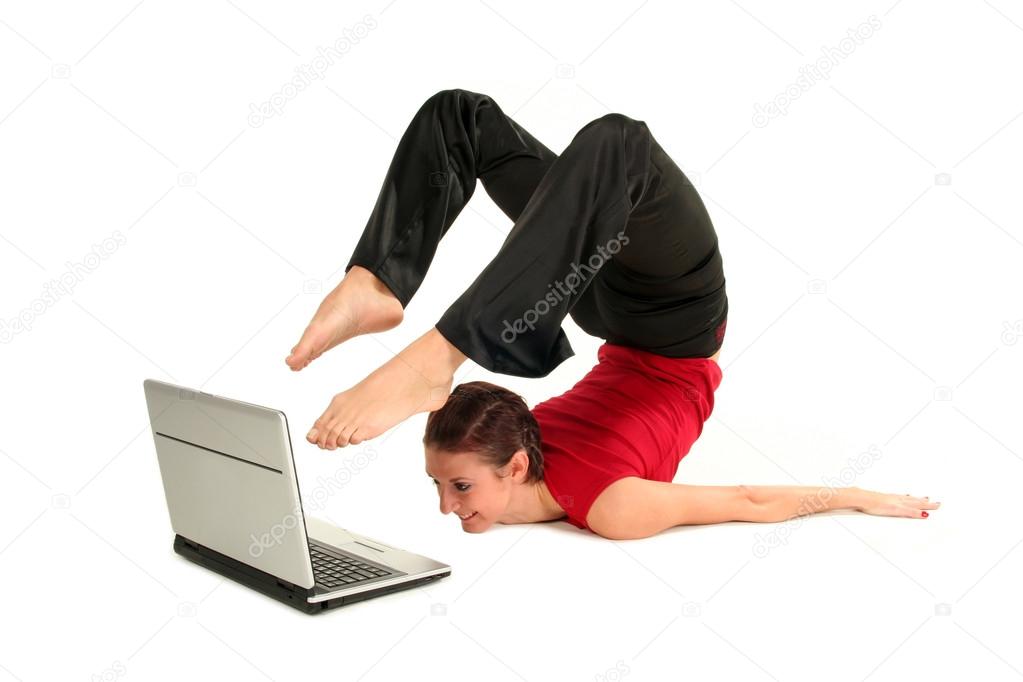 Woman doing yoga with laptop