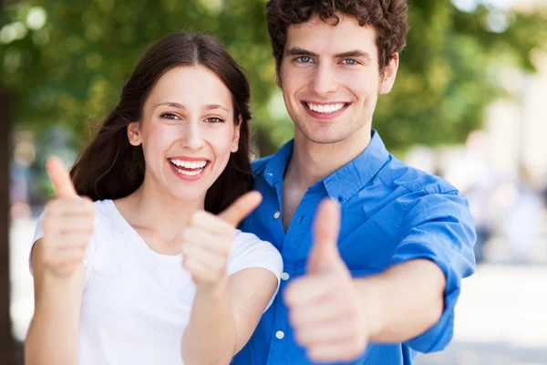 Teenage couple with thumbs up Stock Picture