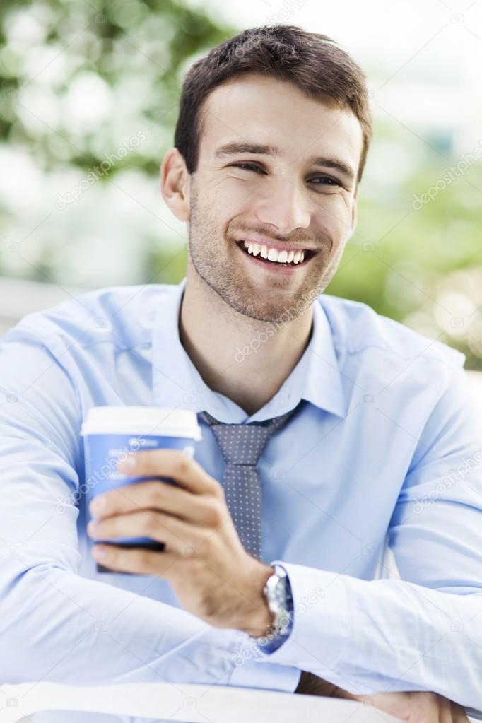 Young man outdoors with coffee