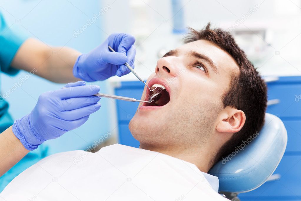 Man having teeth examined at dentists