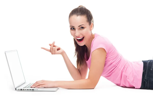 Woman with laptop lying on the floor Stock Image