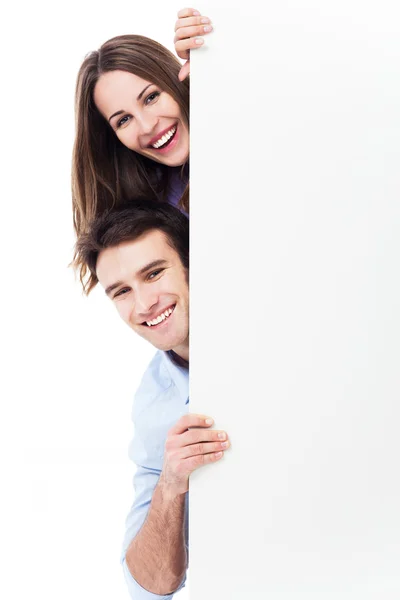Young couple holding a placard — Stock Photo, Image