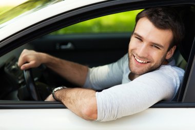 Arabada oturan adam.