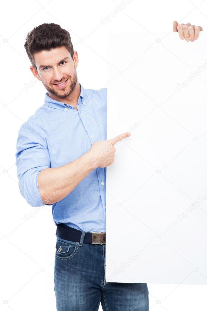Man pointing at blank poster