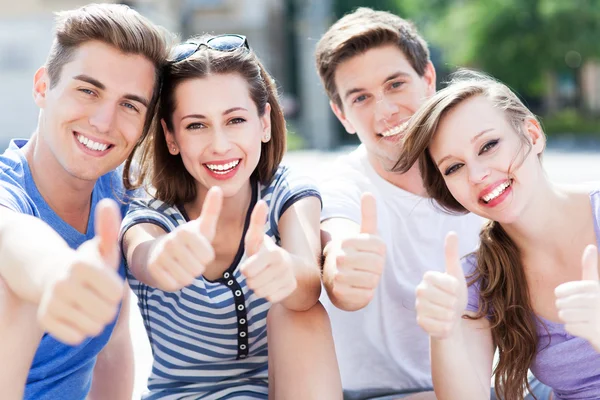 Young people with thumbs up — Stock Photo, Image