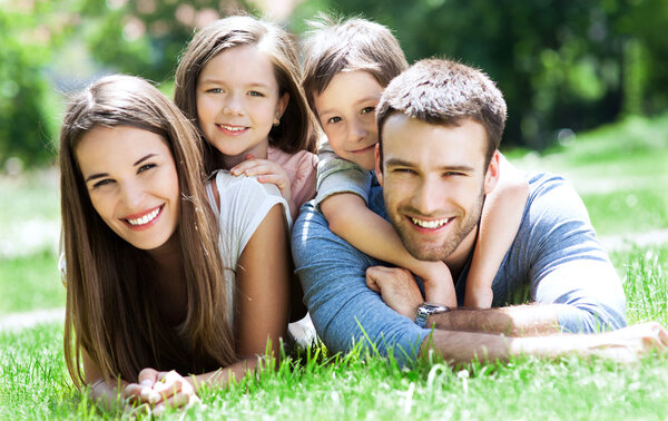 Family outdoors lying on grass