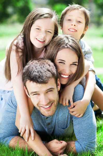 Family outdoors lying on grass