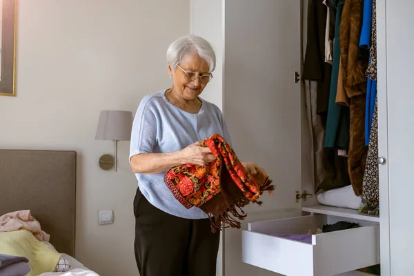Senior Woman Sorting Out Wardrobe — Stock Photo, Image