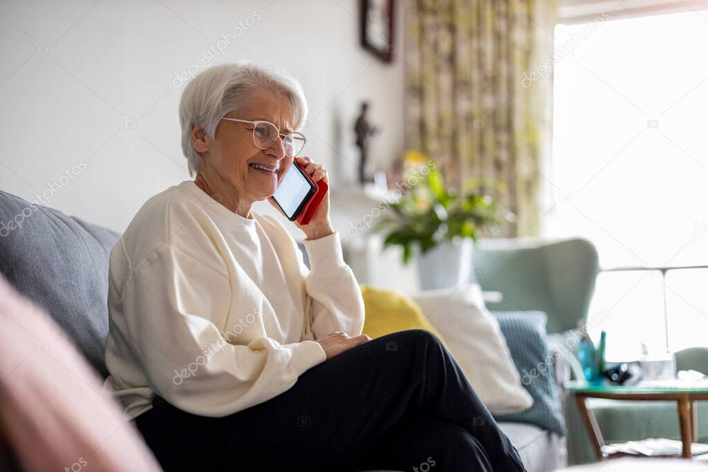 Portrait of senior woman using smartphone at home