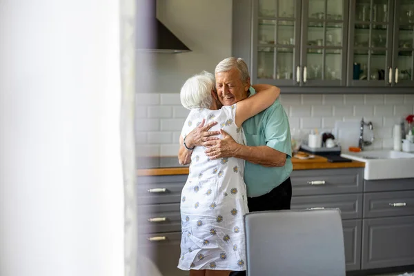 Coppia Anziana Che Abbraccia Nella Loro Cucina — Foto Stock